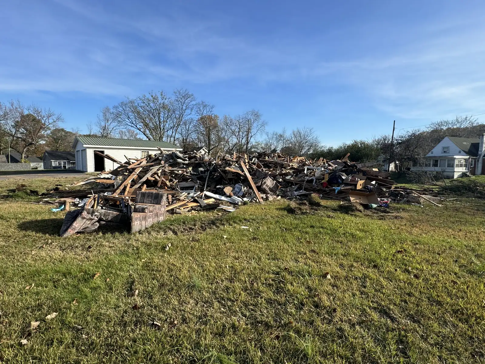 Demolition debris piled on the lot where the house stood